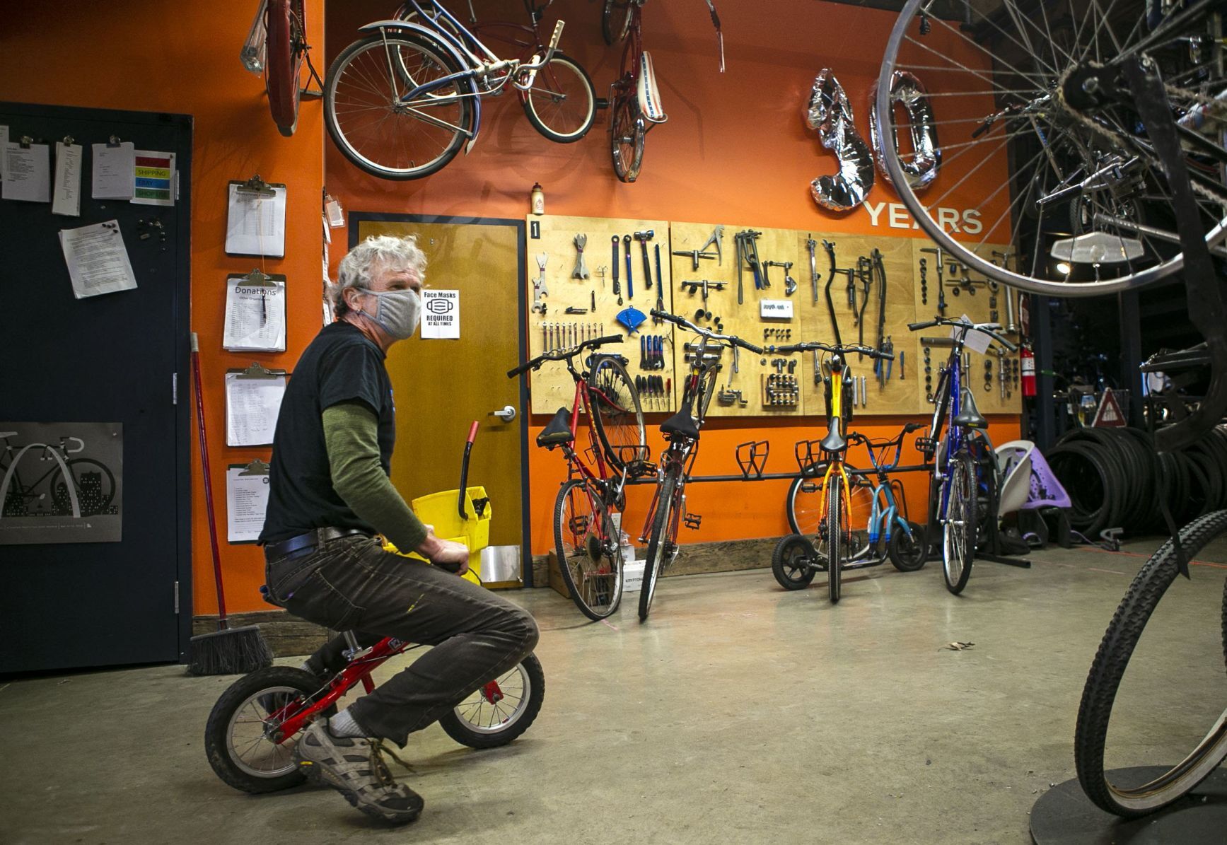 Volunteers and employees repair bikes at St. Louis BWorks in Soulard